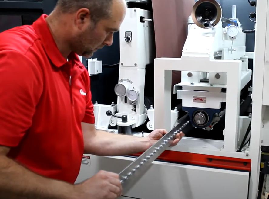 Timesavers service worker examines metal component